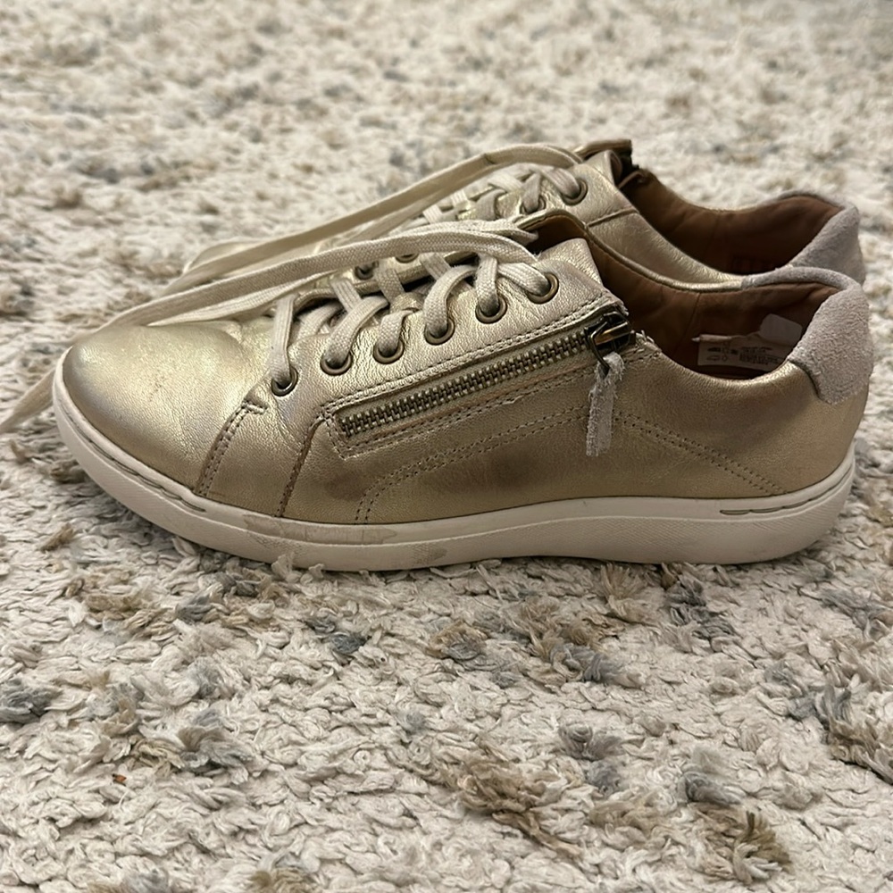 Gold Clarks tennis shoes
